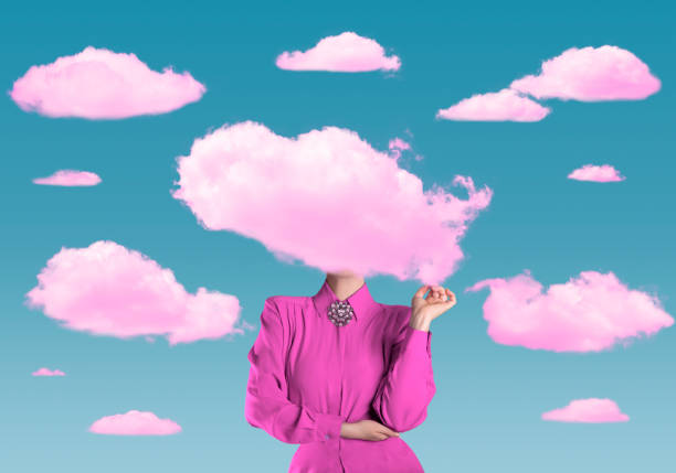 A person in a pink outfit stands with their head replaced by a pink cloud, surrounded by similar clouds against a clear blue sky.